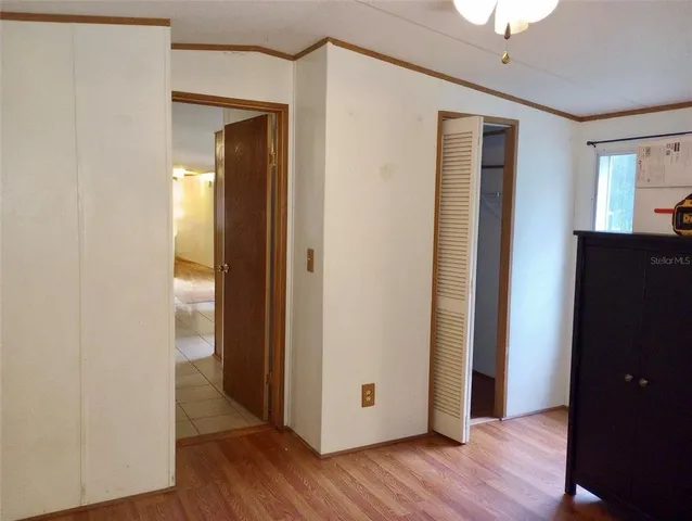 a view of a hallway with wooden floor