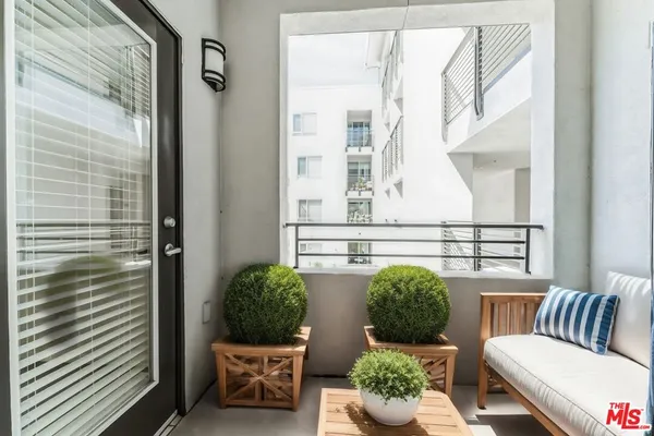 a view of a balcony filled with furniture