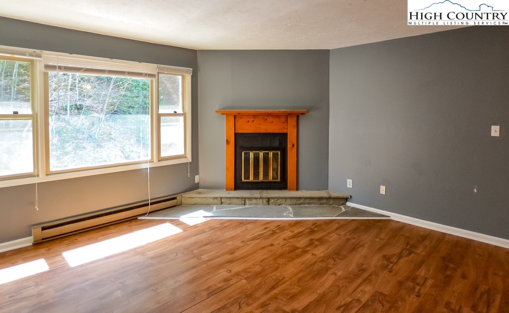 200 Pilgrims Way, Unit 25 Boone, NC 28607 - Photo 2 of 12 a view of an empty room with wooden floor and a window