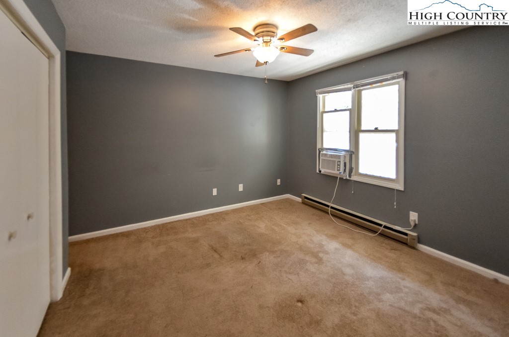 200 Pilgrims Way, Unit 25 Boone, NC 28607 - Photo 7 of 12 an empty room with windows and fan