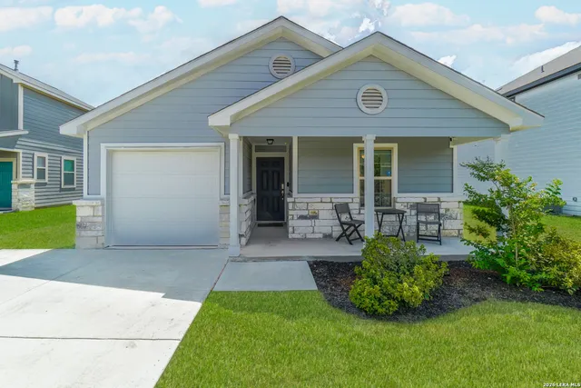 a front view of house with yard and outdoor seating