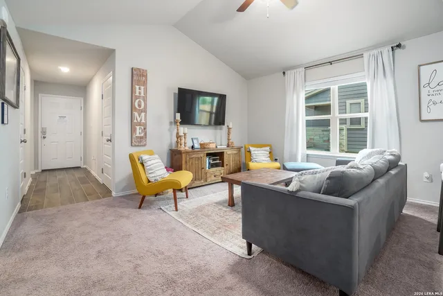 a living room with furniture and a large window