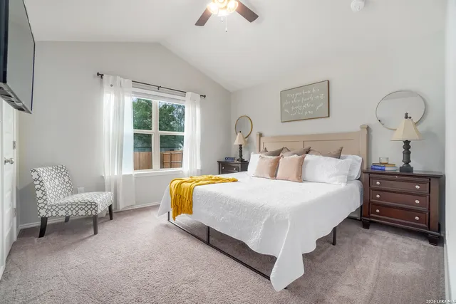 a bedroom with bed and a chandelier