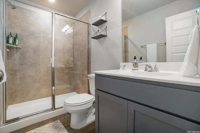 a bathroom with a sink toilet and shower