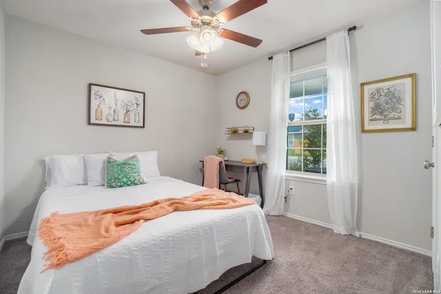 a spacious bedroom with a bed and a window