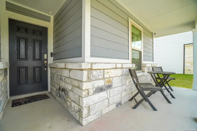 a view of an outdoor sitting area with brick walls