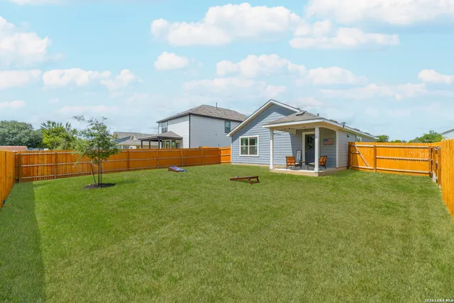 a view of a house with a backyard