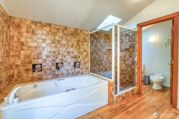 a bathroom with a bathtub and a shower