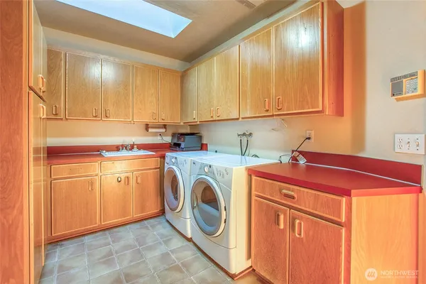 a utility room with sink dryer and washer