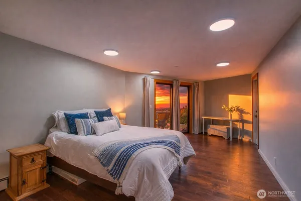 a spacious bedroom with a bed and a table in it