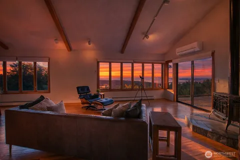 a living room with furniture and a floor to ceiling window