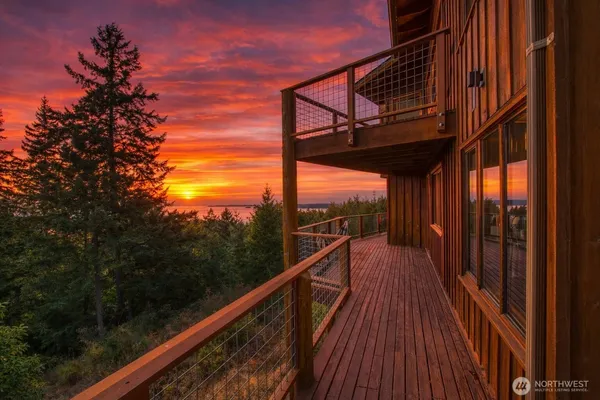 a view of balcony with wooden floor and fence