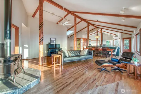 a living room with furniture or couch and a dining table next to a large window