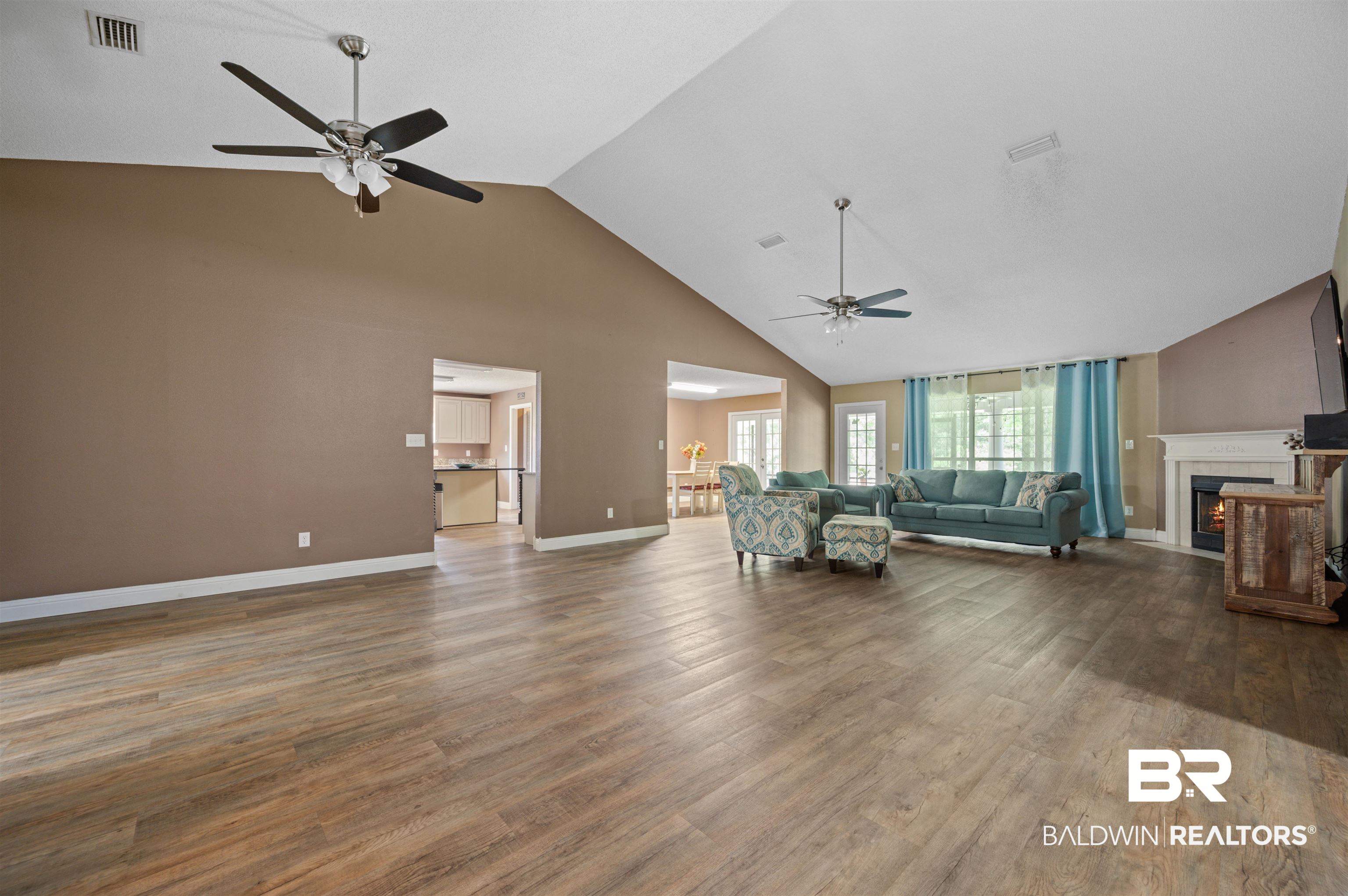 11705 Venice Boulevard Foley, AL 36535 - Photo 16 of 43 Unfurnished living room with high vaulted ceiling, hardwood / wood-style flooring, and ceiling fan