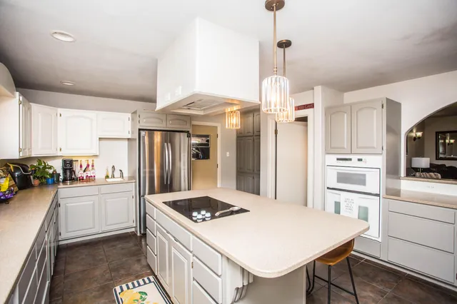 a kitchen with a white stove top oven and refrigerator