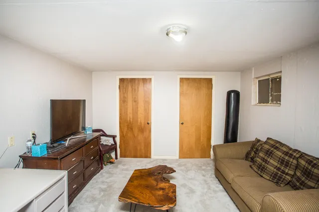 a bedroom with furniture and a flat screen tv