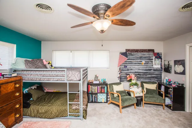 a bedroom with furniture and a chandelier