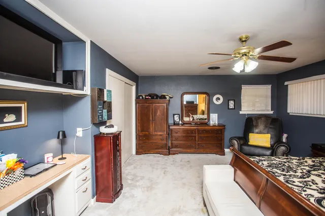 a bedroom with a bed and a television