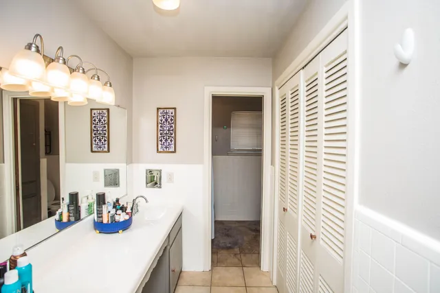a bathroom with a sink a mirror and a shower