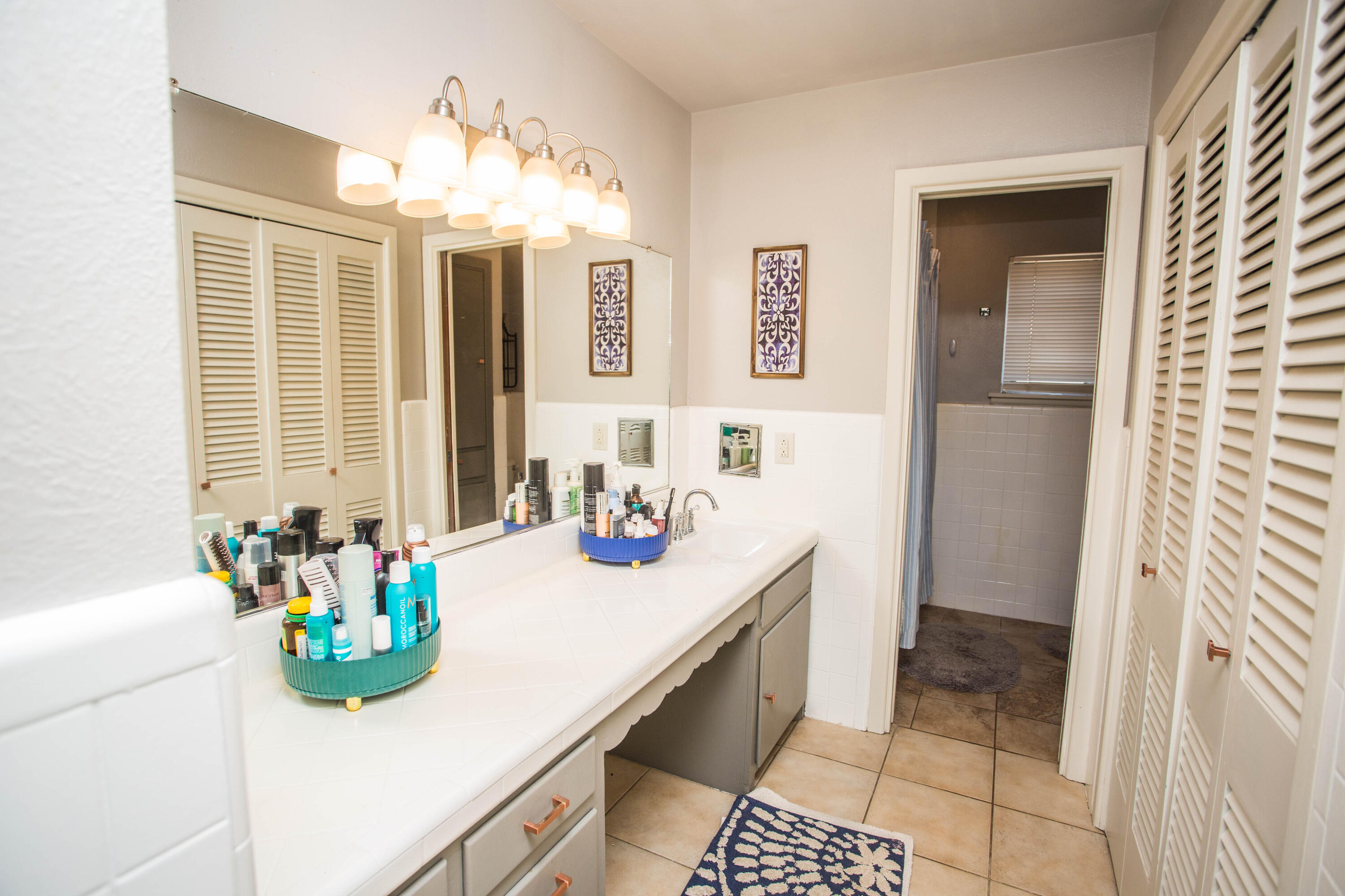 812 1st Street Abernathy, TX 79311 - Photo 45 of 53 a bathroom with a sink a mirror and a shower