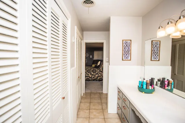 a view of a porch with chairs and potted plants