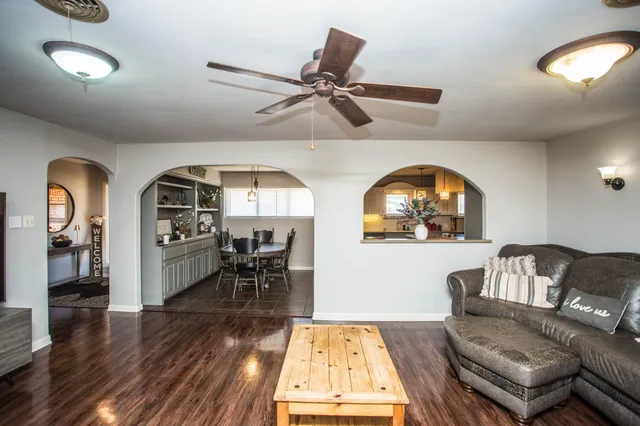 a living room with furniture and wooden floor
