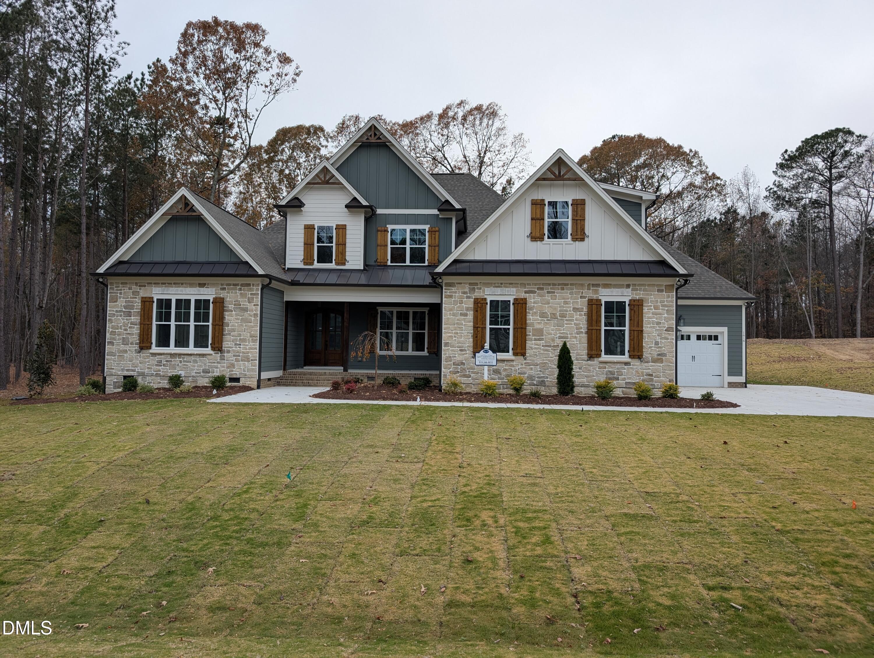 a front view of a house with swimming pool having outdoor seating