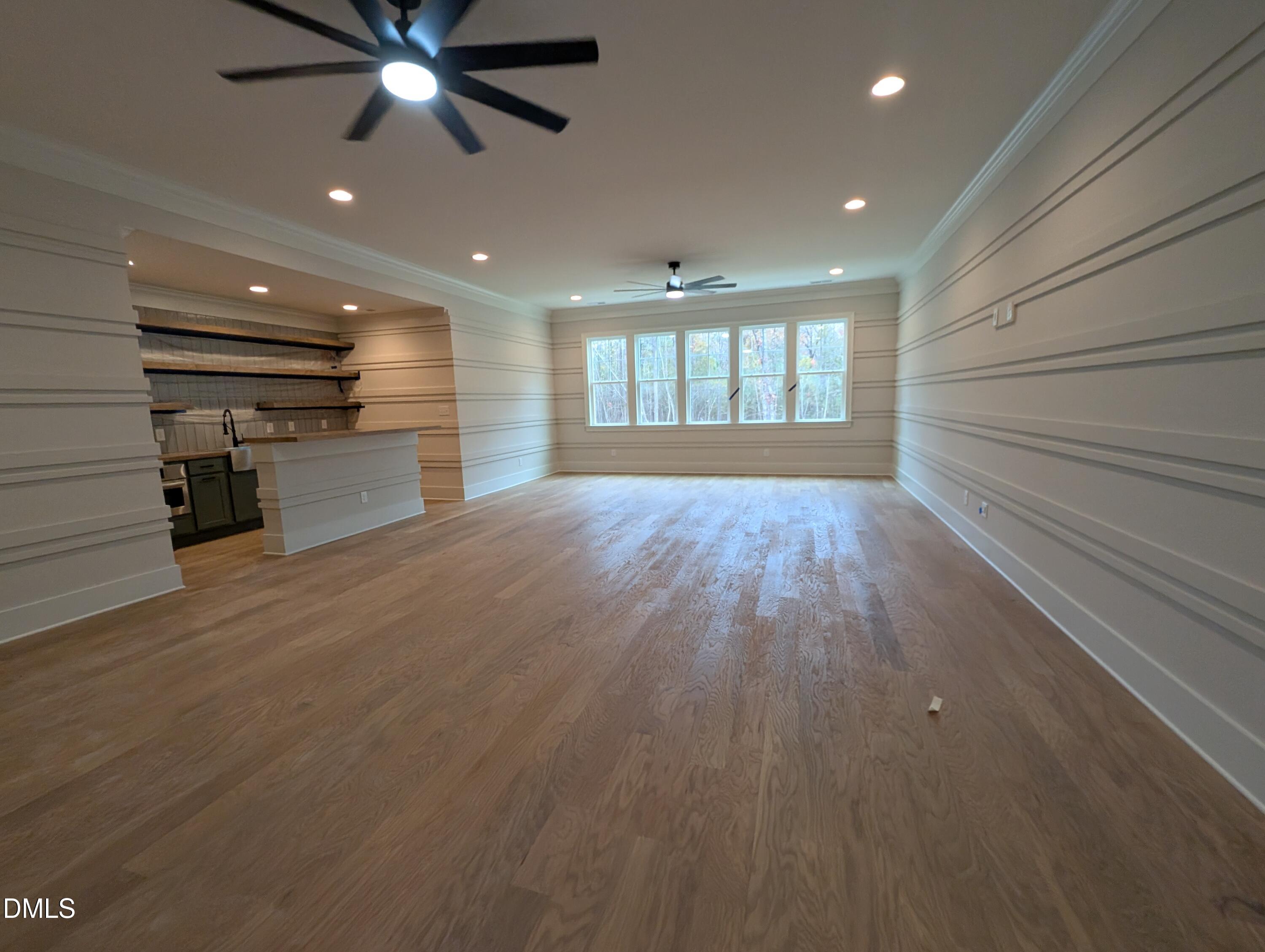 1616 River Bend Lane Raleigh, NC 27610 - Photo 38 of 54 an empty room with wooden floor a ceiling fan and windows