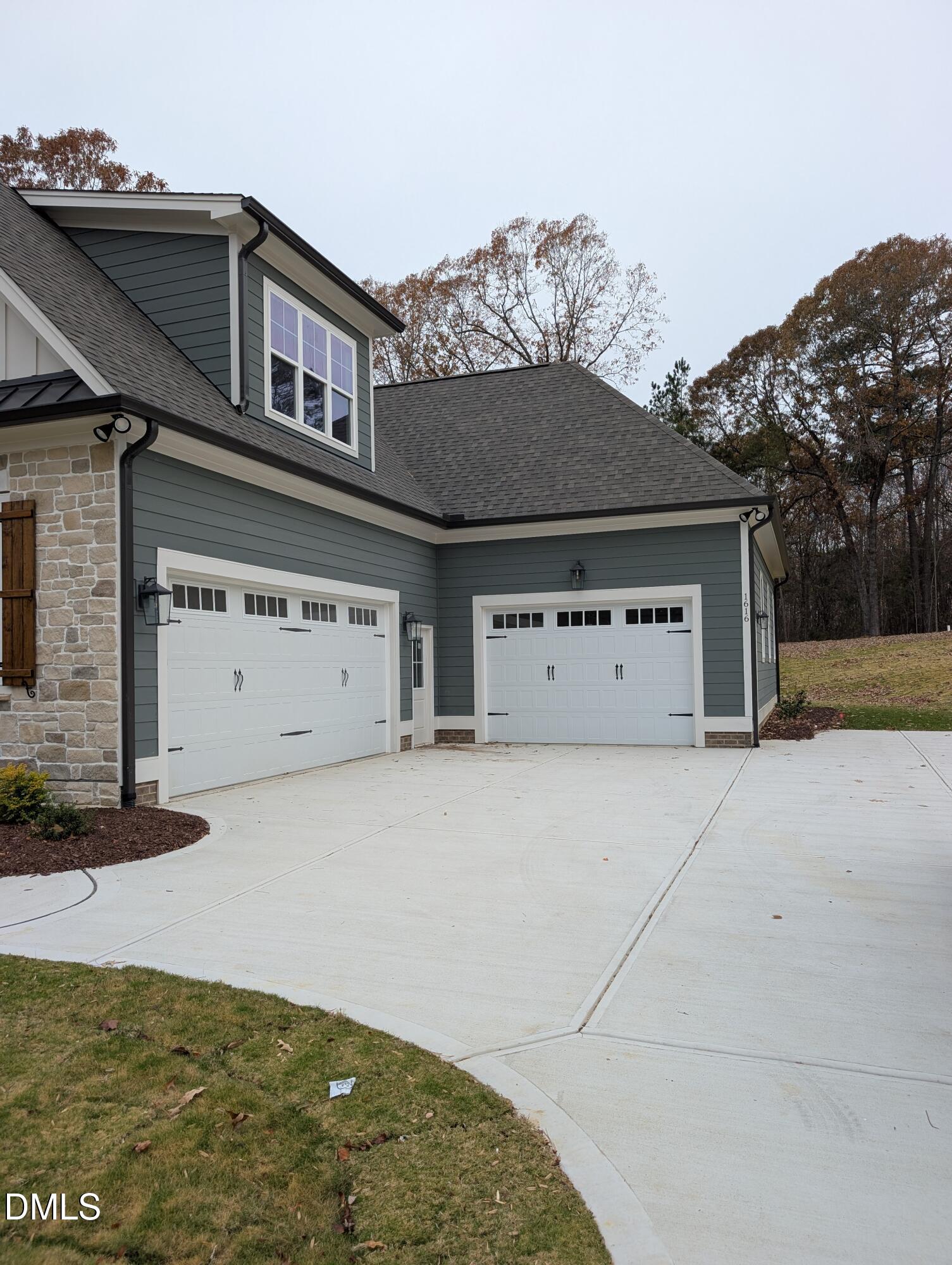 1616 River Bend Lane Raleigh, NC 27610 - Photo 3 of 54 a front view of a house with a garage