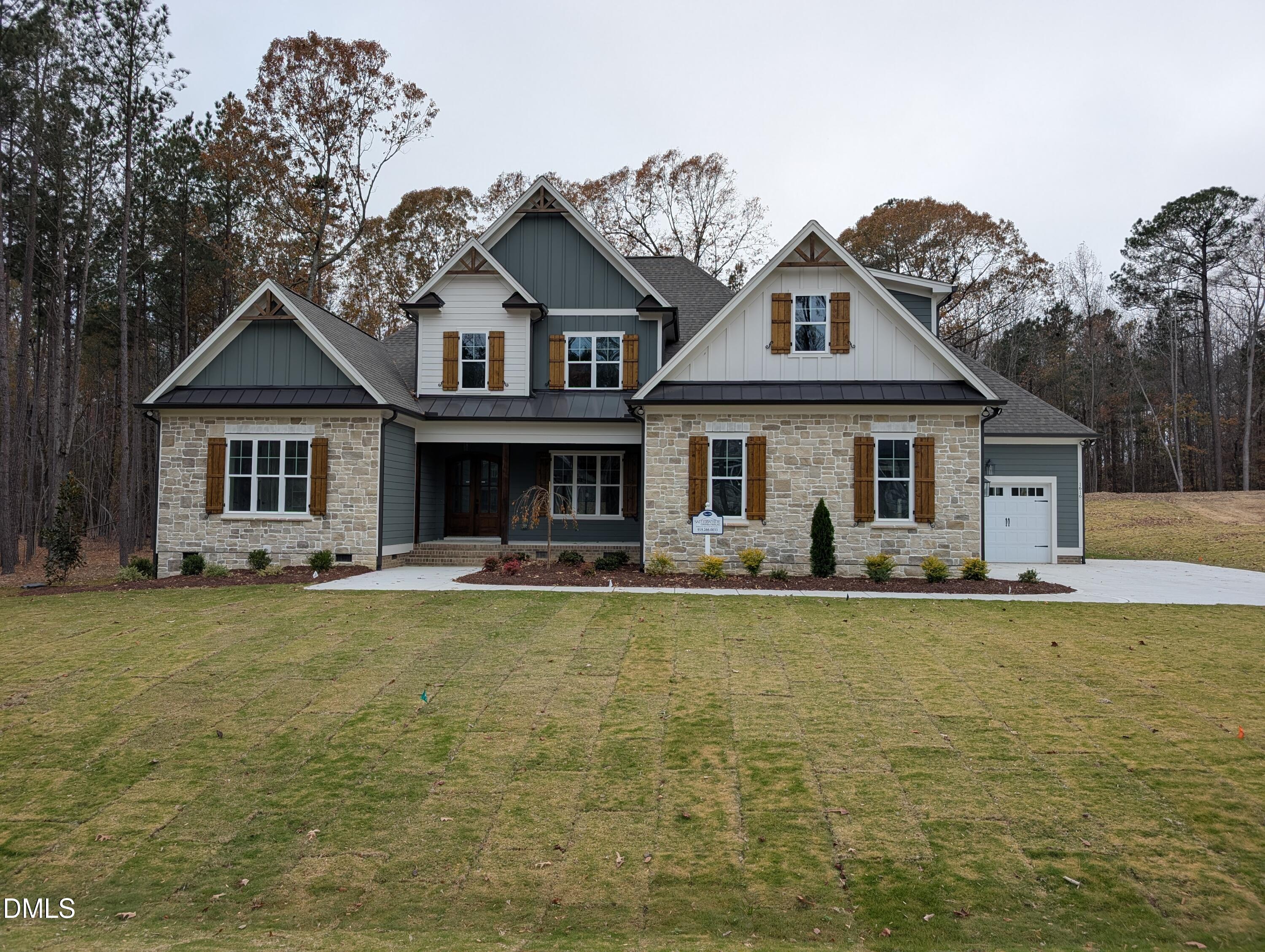 1616 River Bend Lane Raleigh, NC 27610 - Photo 49 of 54 a front view of a house with a garden and porch