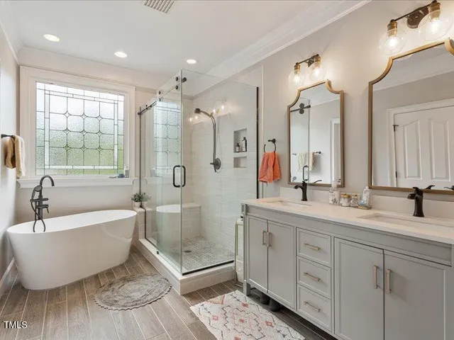 a bedroom with a bed and a flat tv screen on dresser