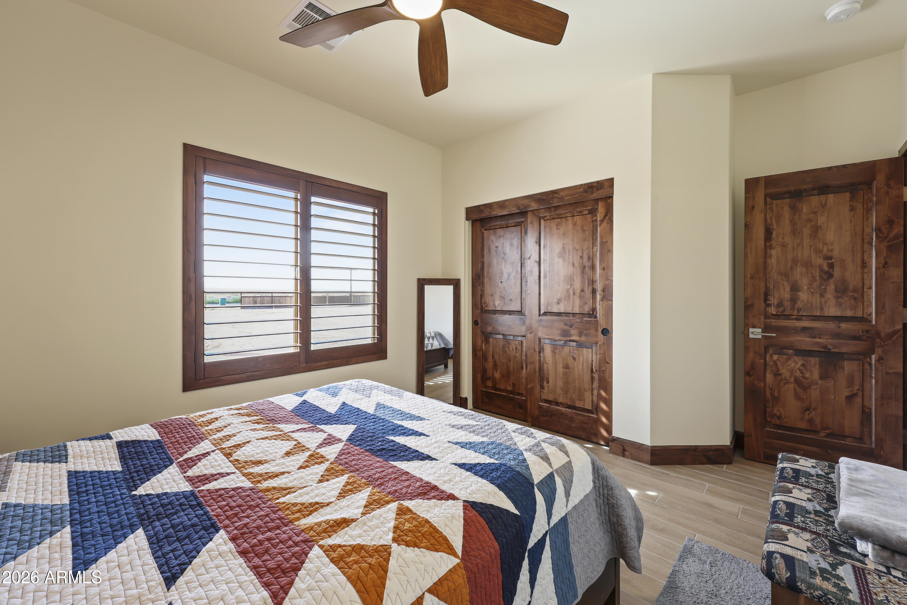 49370 West Val Vista Road Maricopa, AZ 85139 - Photo 12 of 58 a bedroom with a bed and wooden floor