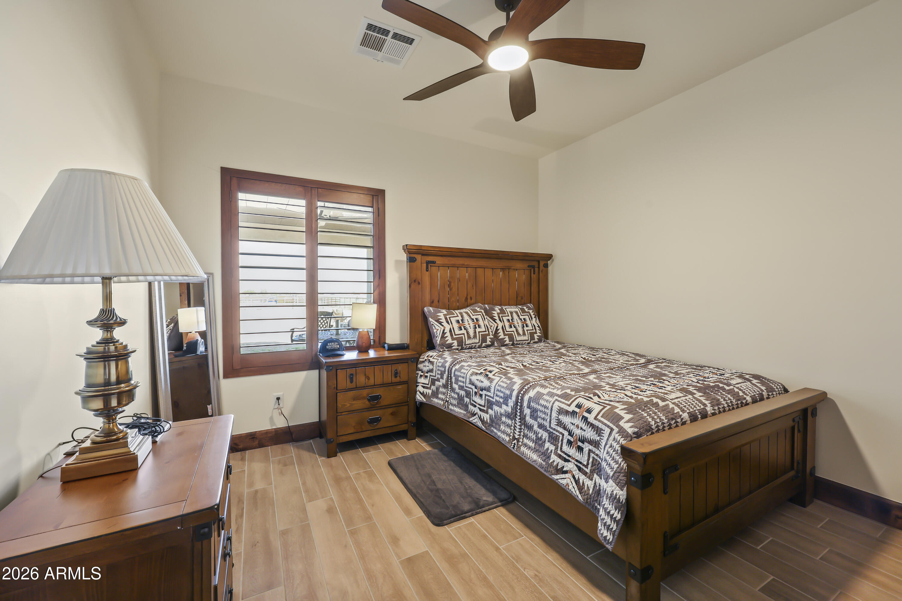 49370 West Val Vista Road Maricopa, AZ 85139 - Photo 17 of 58 a bedroom with a bed and a chandelier