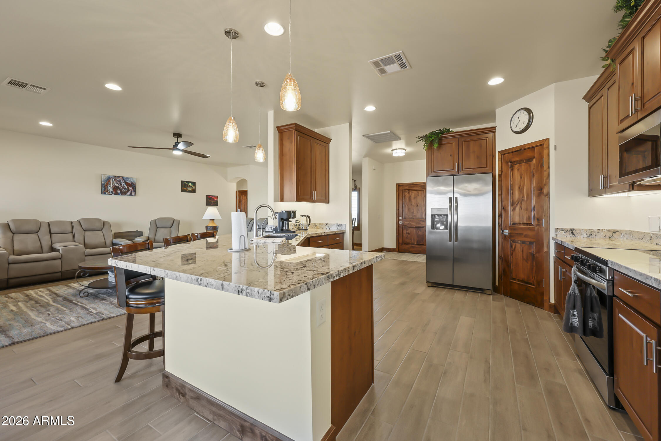 49370 West Val Vista Road Maricopa, AZ 85139 - Photo 31 of 58 a kitchen with stainless steel appliances kitchen island granite countertop a sink and a refrigerator