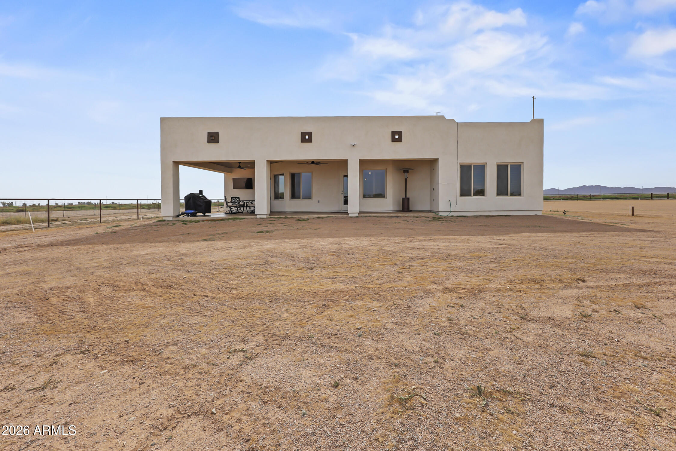49370 West Val Vista Road Maricopa, AZ 85139 - Photo 45 of 58 a view of a big house with a big yard and large trees
