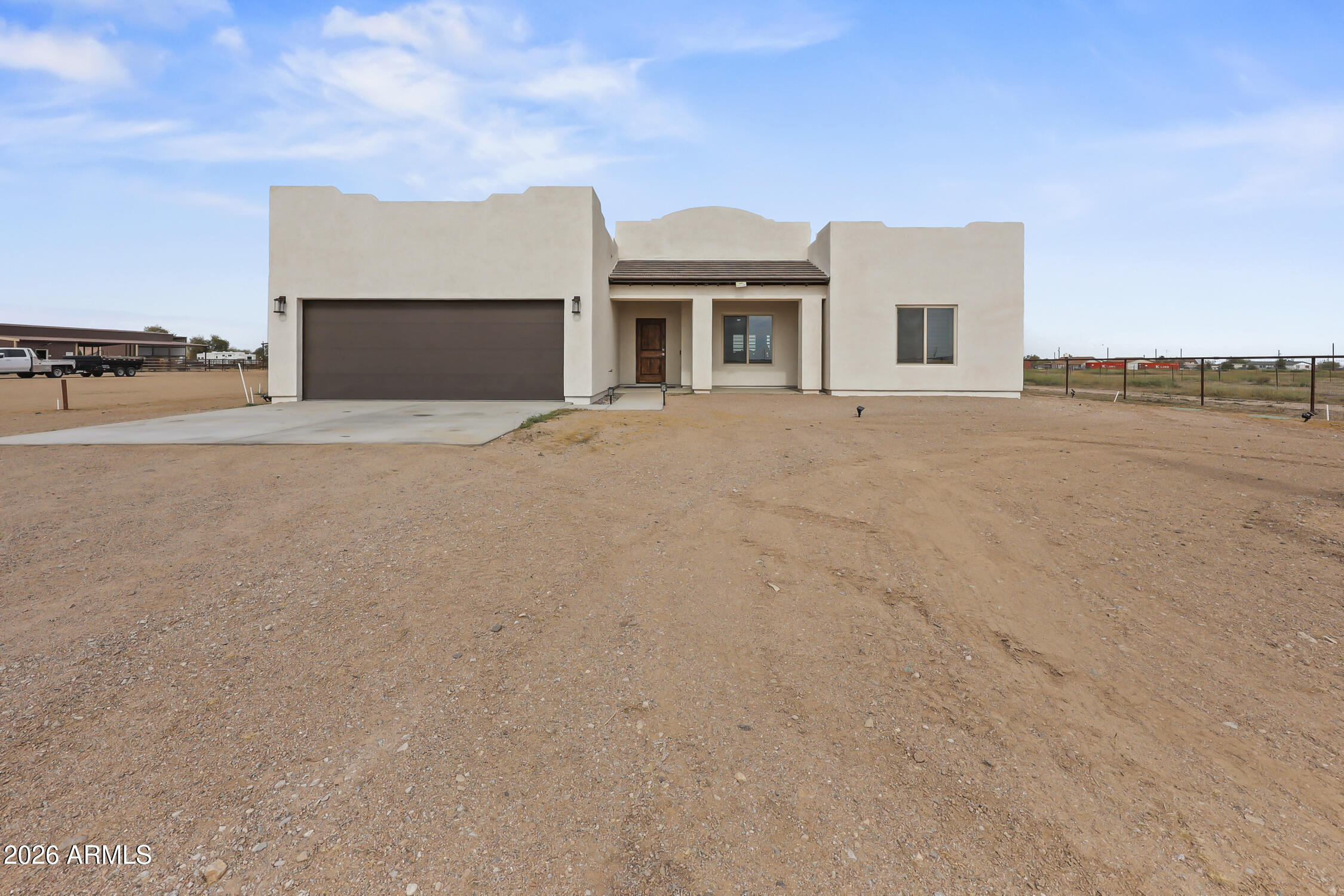 49370 West Val Vista Road Maricopa, AZ 85139 - Photo 48 of 58 a front view of a house with a yard and garage