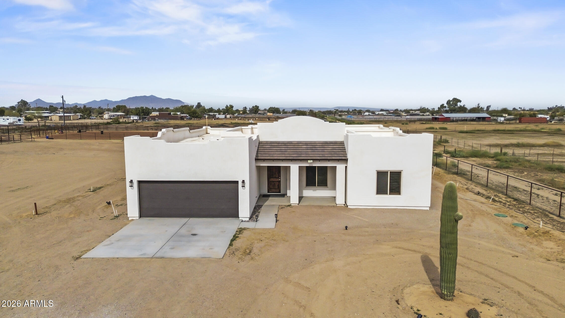 49370 West Val Vista Road Maricopa, AZ 85139 - Photo 57 of 58 a front view of a house with lake view and trees in the background