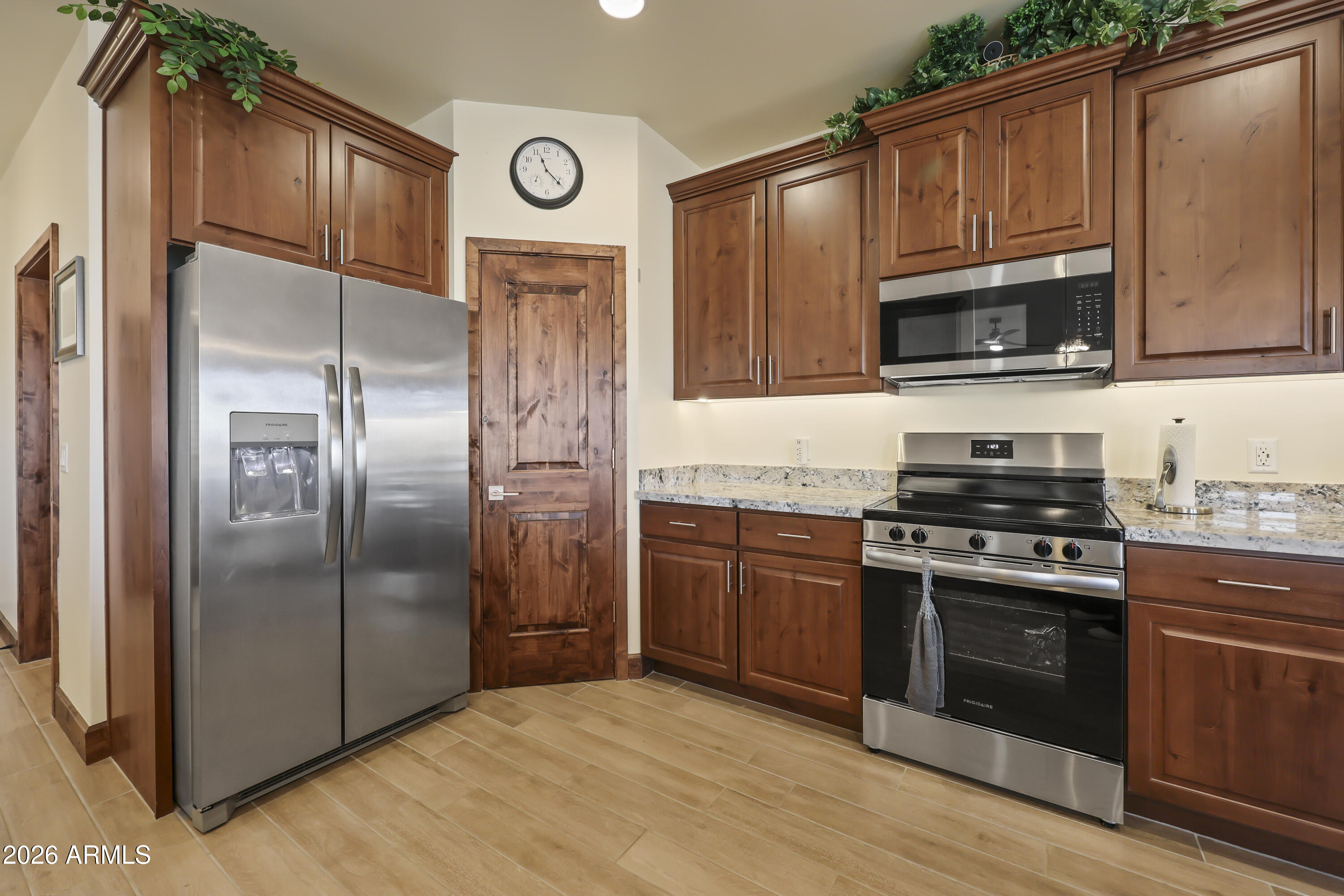 49370 West Val Vista Road Maricopa, AZ 85139 - Photo 6 of 58 a kitchen with granite countertop a refrigerator stove and microwave