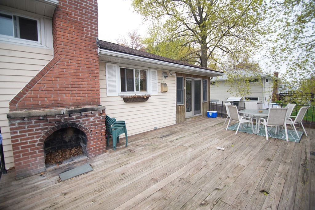 67 Dayton Street Springfield, MA 01118 - Photo 16 of 20 a view of a patio with table and chairs with wooden floor and fence