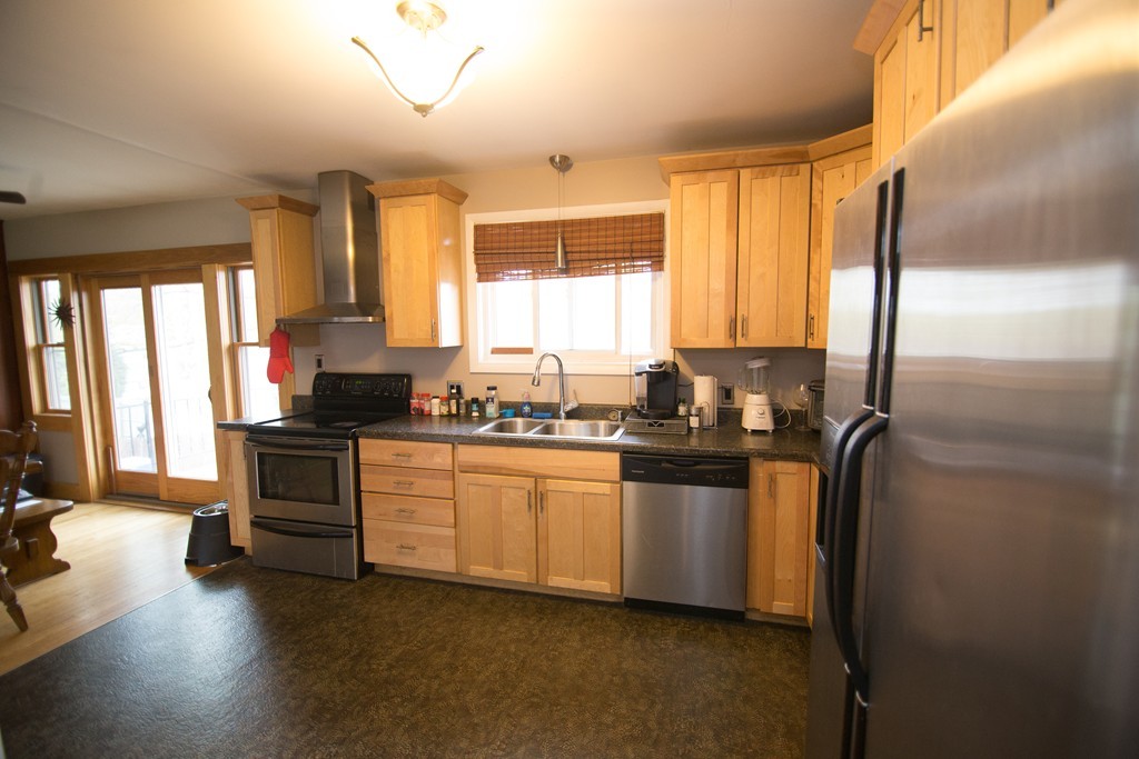 67 Dayton Street Springfield, MA 01118 - Photo 2 of 20 a kitchen with stainless steel appliances granite countertop a refrigerator and a stove