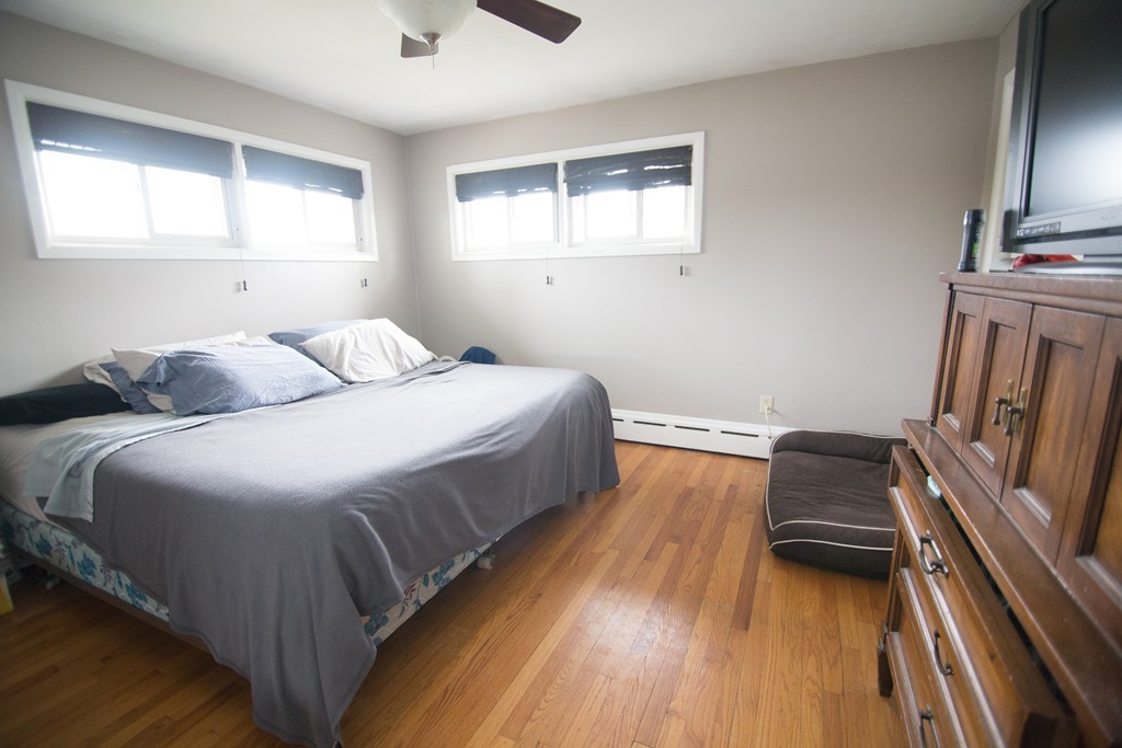 67 Dayton Street Springfield, MA 01118 - Photo 9 of 20 a bedroom with a bed and a flat tv screen on dresser