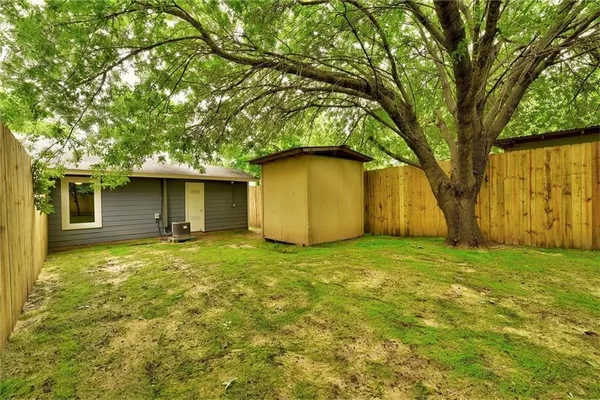 a house with huge tree in front of it