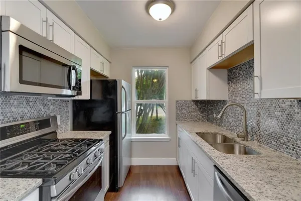 a kitchen with a stove and a microwave