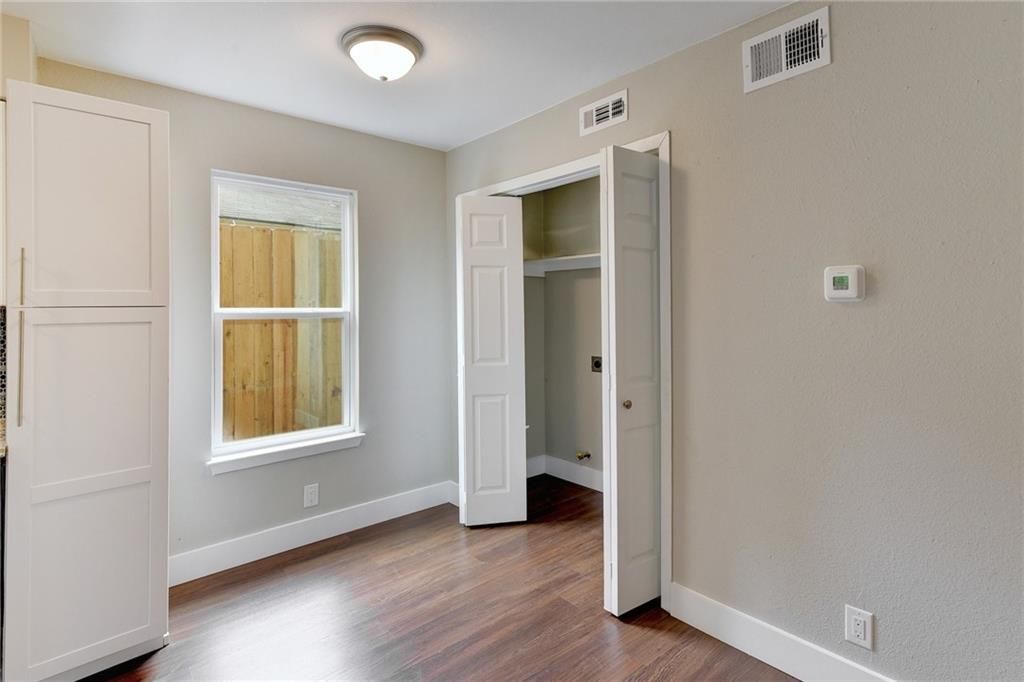 7504 Carver Avenue, Unit A Austin, TX 78752 - Photo 8 of 11 an empty room with wooden floor and windows