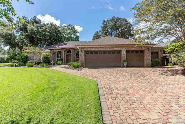 a front view of a house with yard and green space
