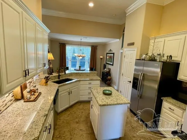 a view of a kitchen with fridge and workspace