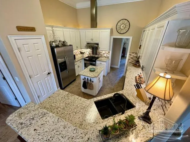a kitchen with a stove a sink and a refrigerator