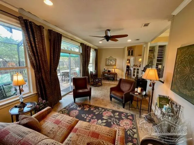 a living room with furniture and a large window