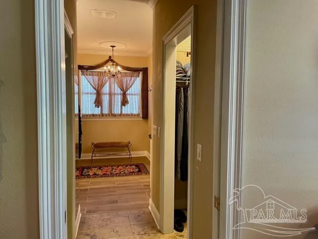 a bedroom with bed and a chandelier