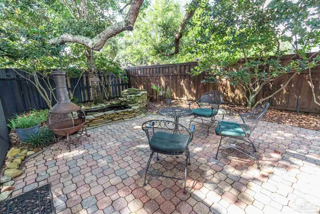 a view of a patio with couches and potted plants